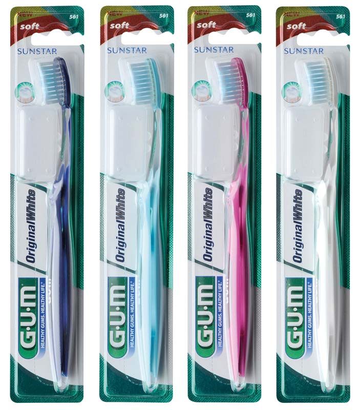 Vier GUM® Original White Zahnbürsten in Verpackung, blau, weiß, pink, hellblau.