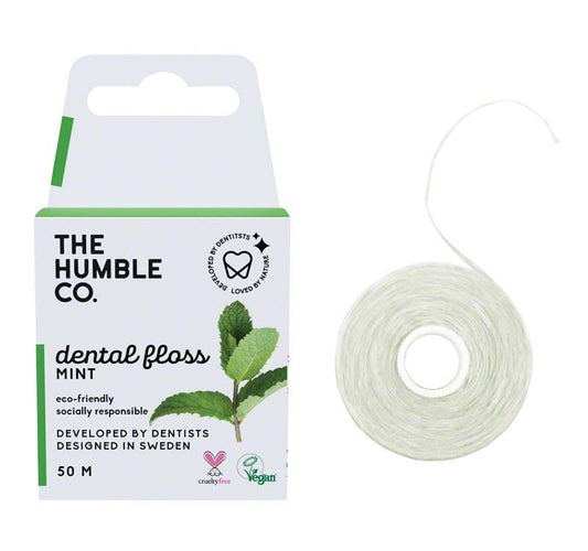Humble Zahnseide Minze Verpackung mit grünem Blattdesign und Spenderrolle.