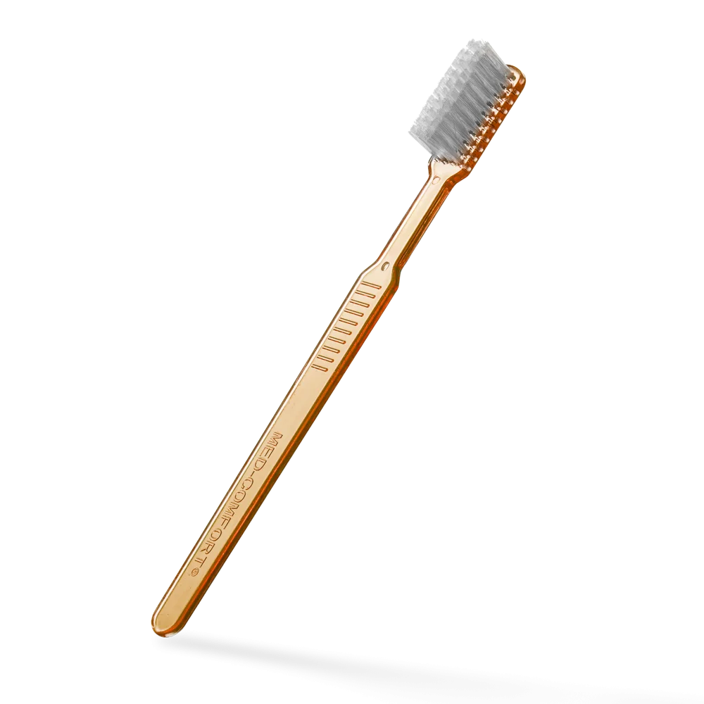 Einwegzahnbürste mit Zahnpasta, orange, aus Polystyrol.