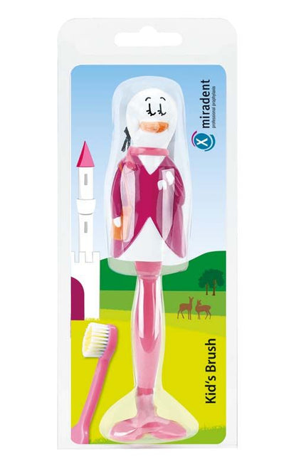 Kinderzahnbürste in Entenform mit rosa Griff in Verpackung vor Schlossmotiv.