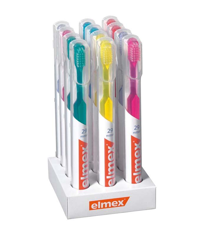 Kurzkopfzahnbürsten elmex® 29 mittel in verschiedenen Farben in hygienischer Verpackung.
