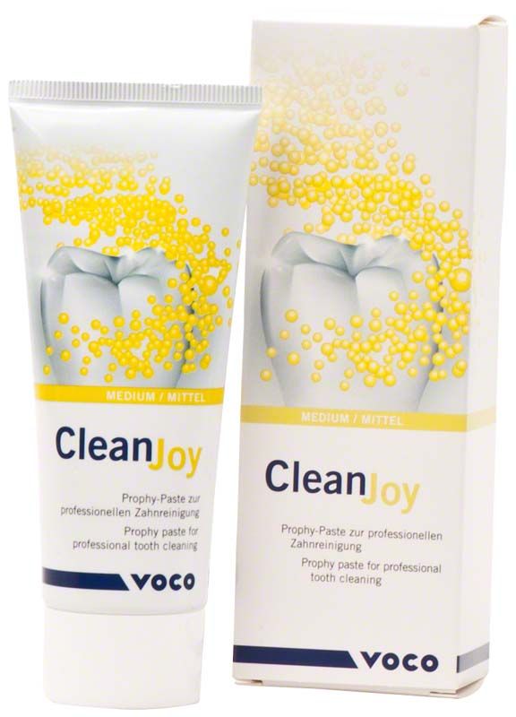 Zahnreinigungspaste CleanJoy® Tube mittel neben Verpackung mit Zahnmotiv.