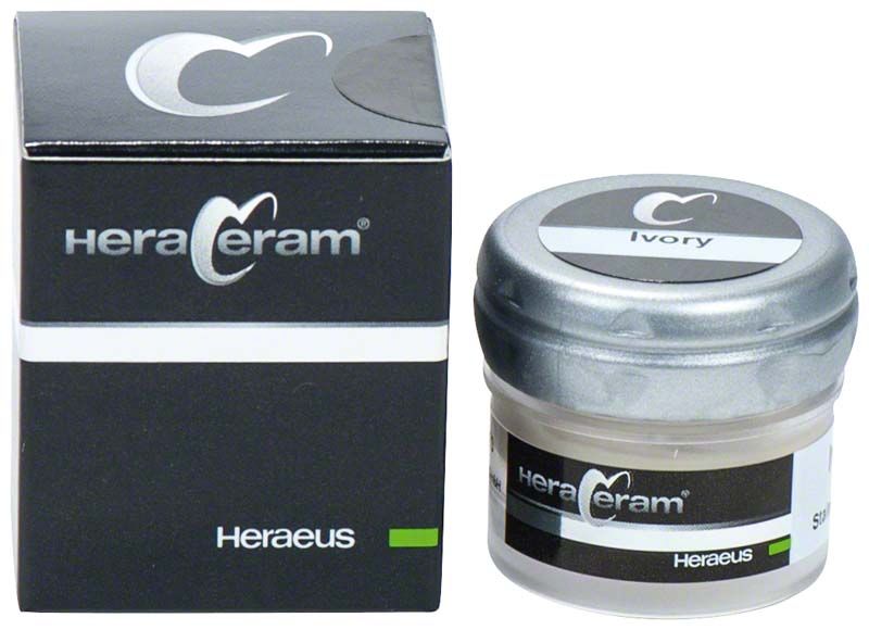HeraCeram® Stains universal Paste Ivory in schwarzer Verpackung mit Glasbehälter.