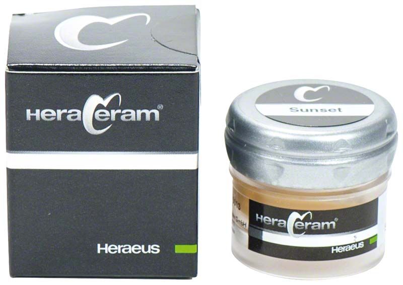 HeraCeram® Stains universal Paste Sunset in Glasbehälter neben schwarzer Verpackung.