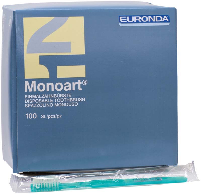 Einzelverpackte grüne Einmalzahnbürste vor Monoart-Verpackung.