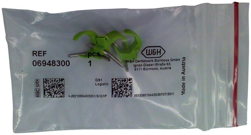 Sprayclip grün rechts für dentalmedizinische Winkelstücke in Verpackung.