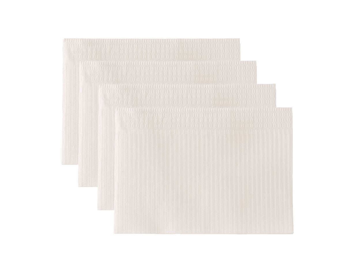 Vier weiße Monoart Patientenservietten mit zweifachem Schutz und hoher Saugfähigkeit.