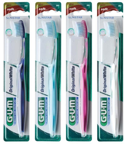Vier GUM® Original White Zahnbürsten in Verpackung, blau, weiß, pink, hellblau.