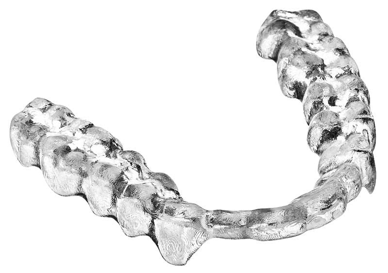 Detailansicht einer silbernen Aufbissschiene aus flexiblem Harz.