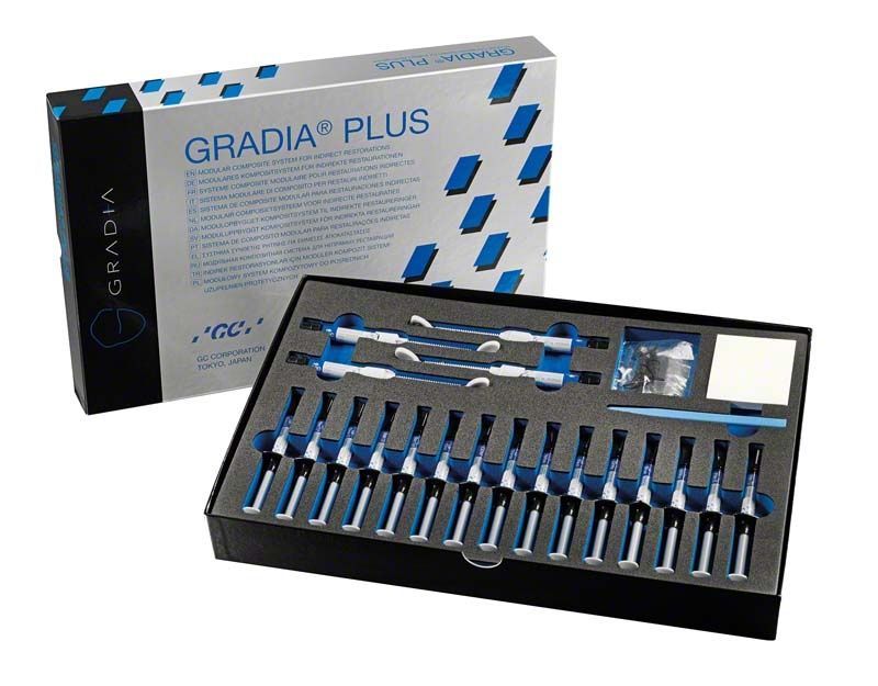 GRADIA® PLUS Layer-Pro Set mit verschiedenen Zahnmaterialien und Werkzeugen in geöffneter Verpackung.