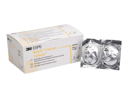 3M RelyX Unicem Aplicap Verpackung und zwei versiegelte Kapseln.