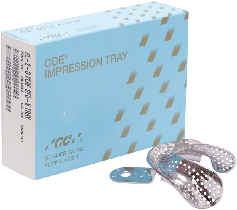 Metall-Löffel für Zahnabdrücke neben blauer Verpackung.