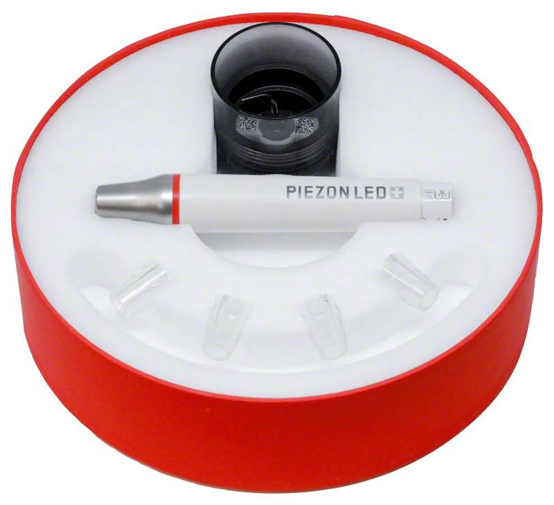 Ultraschallhandstück PIEZON® LED in roter Verpackung mit Zubehör.