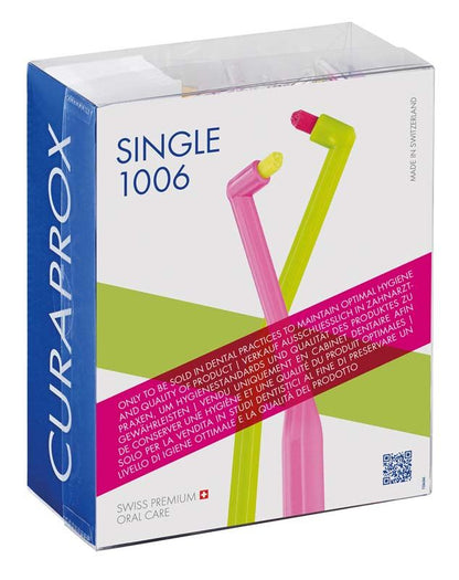CURAPROX sensitive CS 1006 Single Zahnbürste in Verpackung mit grünem Griff und pinkem Kopf.