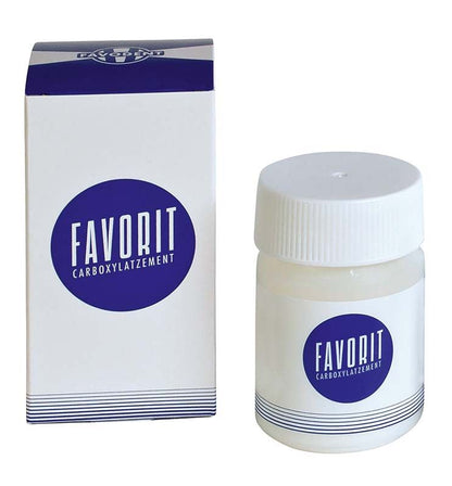 FAVORIT Carboxylatzement 90g Pulver in Glasbehälter neben Verpackung.