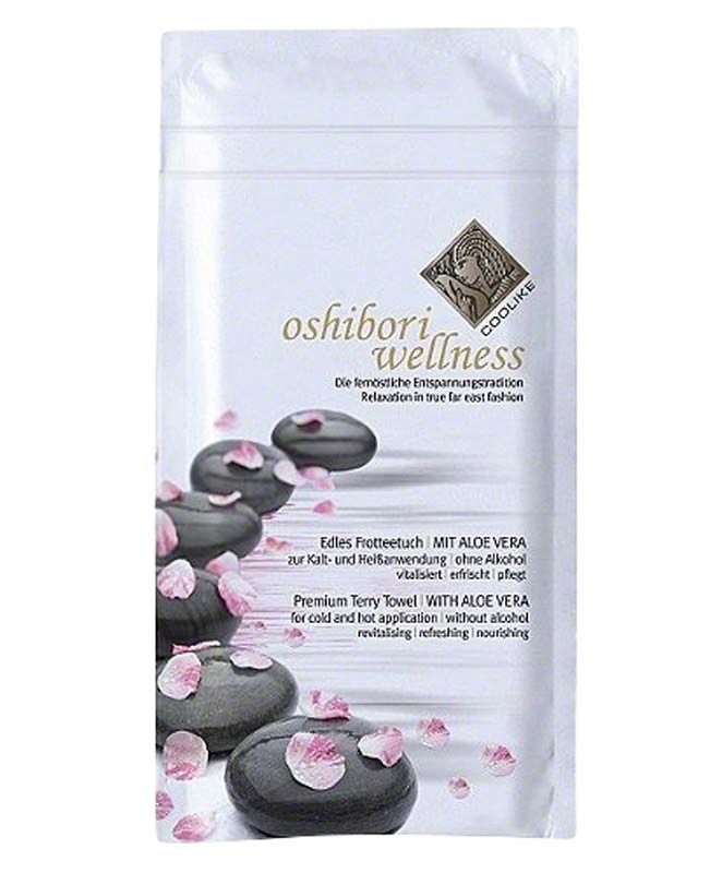 Frottee-Tuch Oshibori Wellness Verpackung mit Steinen und Blüten.