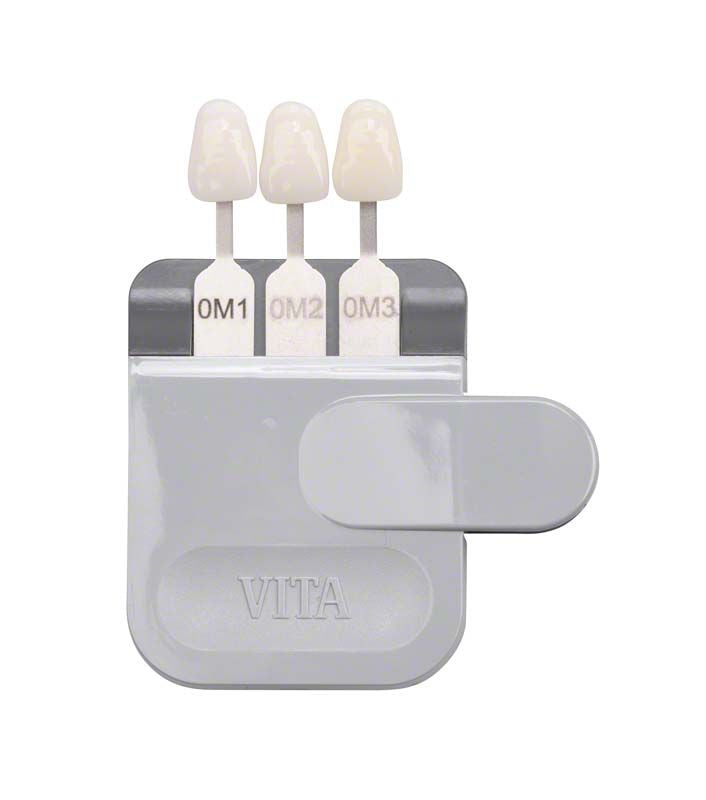 VITA Farbskala mit drei gebleachten Farbstäbchen auf grauem Halter.