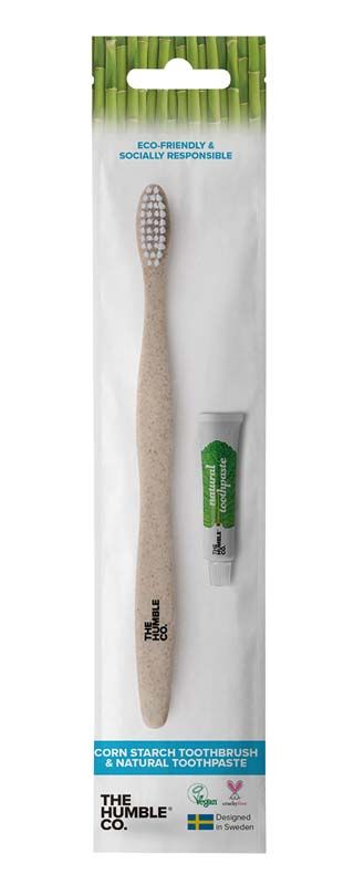 Humble Brush Zahnbürste mit weißem Griff und Zahncreme in Verpackung.