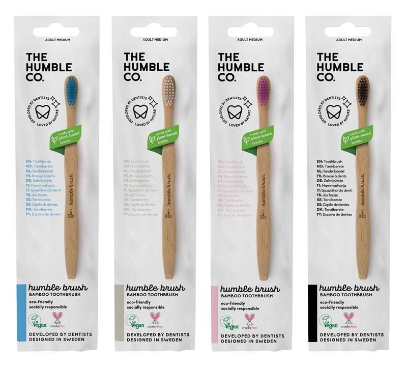 Vier Humble Brush Zahnbürsten in Verpackung, mit unterschiedlicher Borstenfarbe.