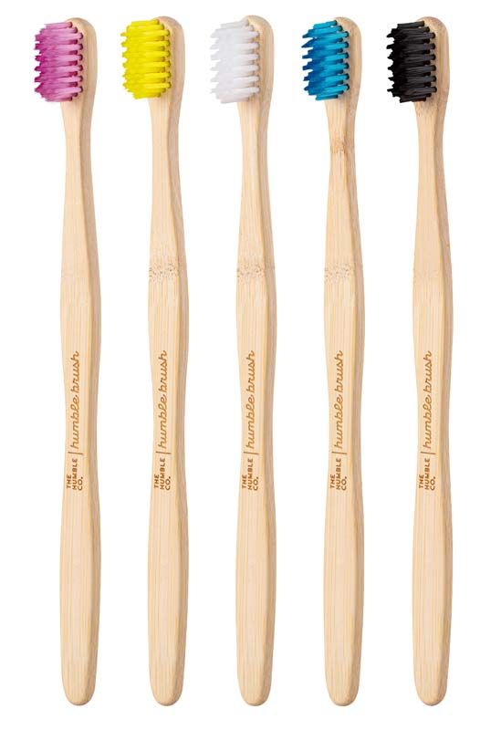Fünf Humble Brush Zahnbürsten mit bunten weichen Borsten auf weißem Hintergrund.