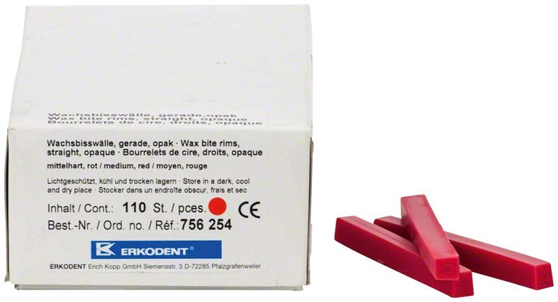 Wachsbisswälle in rot-opak neben Verpackung mit Produktinformationen.