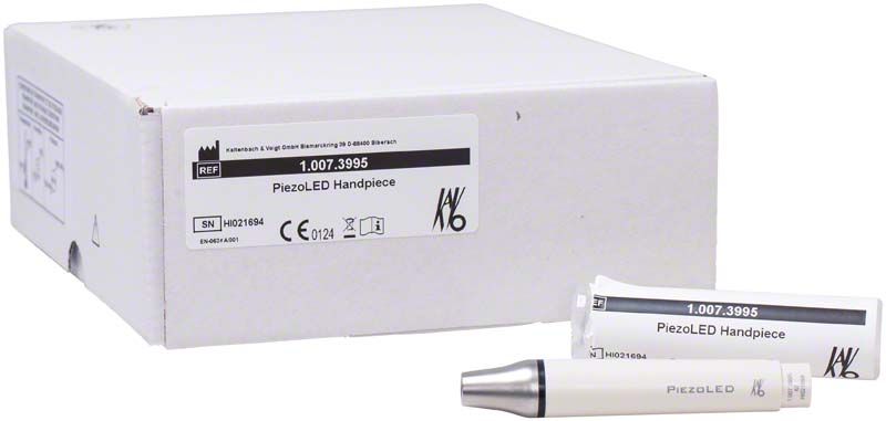 PiezoLED Handstück mit Verpackung und Ersatzteil auf weißem Hintergrund.