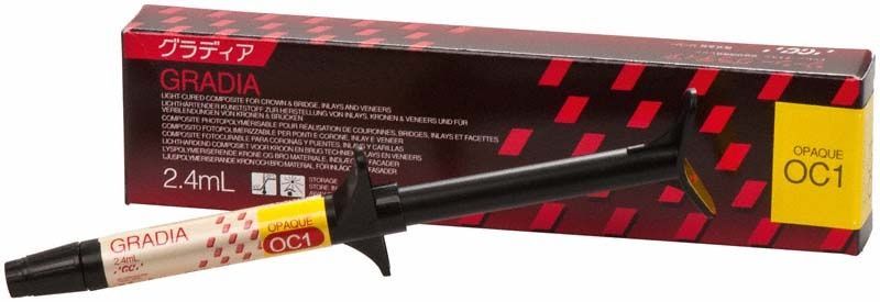 Gradia Opaque OC1 in Spritze vor Verpackung mit rotem Muster.