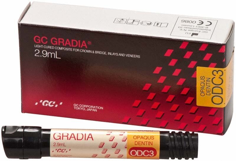 Gradia Opaque Dentin ODC3 Kunststoffverpackung mit Tube im Vordergrund.