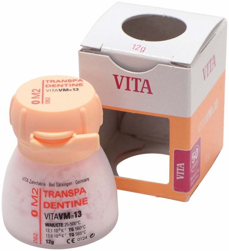 Transpa Dentin VM13 0M2, 12g Dose neben Verpackung.