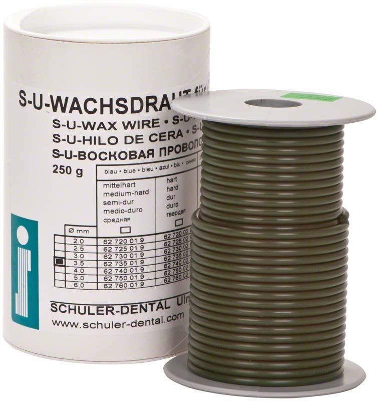 S-U-Wachsdraht grün mittelhart auf Spule neben Produktverpackung.
