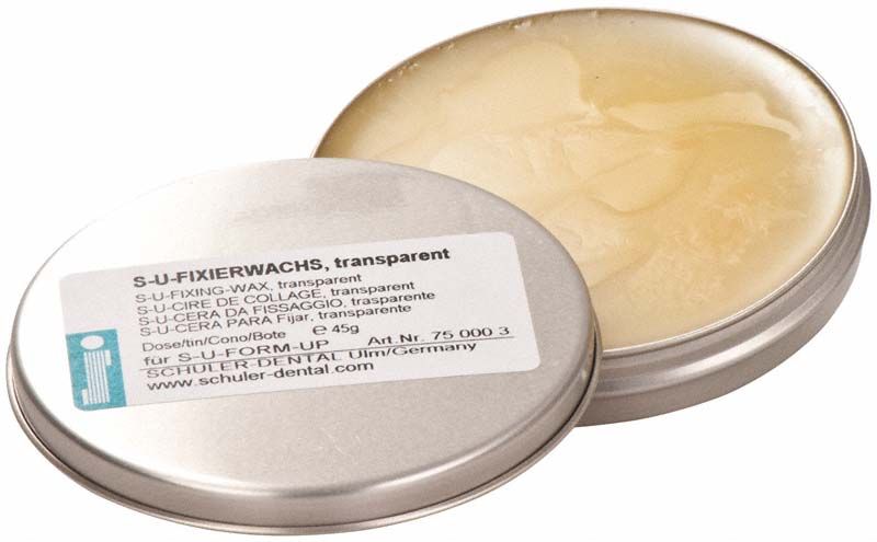 S-U-Form-Up Fixierwachs transparent in geöffneter Metalldose.