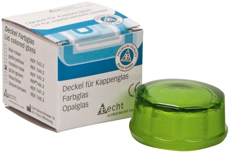Grüner Kappenglasdeckel neben Verpackung mit Aufschrift und Logo.