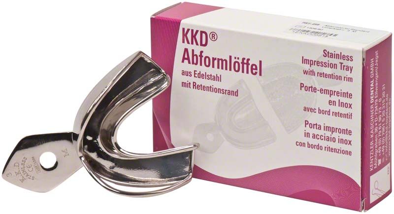 Abformlöffel aus Edelstahl neben Verpackung mit Produktinformationen.