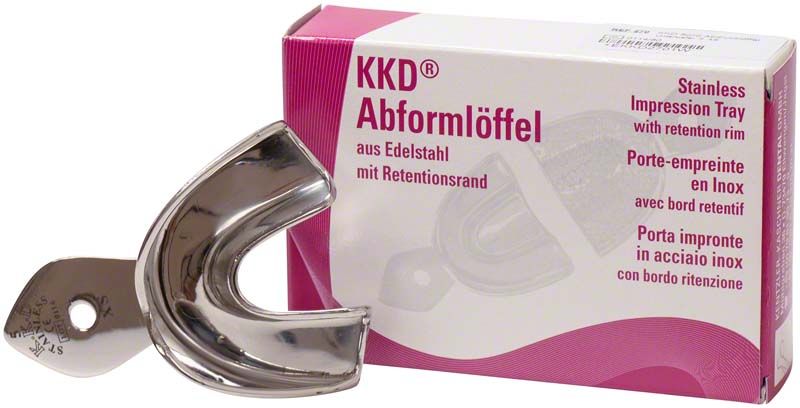 Abformlöffel aus Edelstahl vor Verpackung mit Produktbeschreibung.