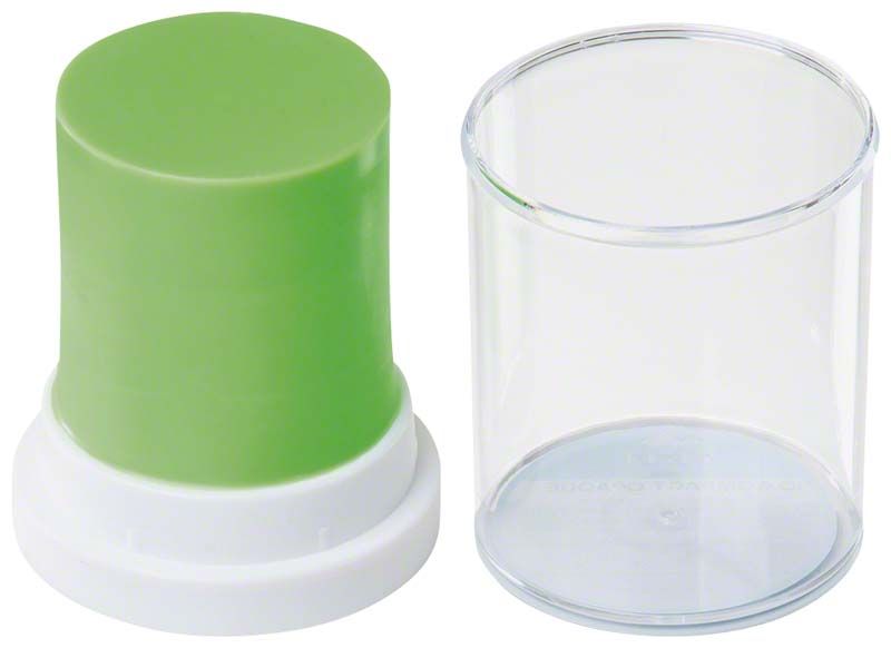 Grünes Modellierwachs in zylindrischer Form mit transparentem Deckel.