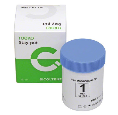 Nicht-imprägnierter Retraktionsfaden in Dose mit Produktverpackung im Hintergrund.