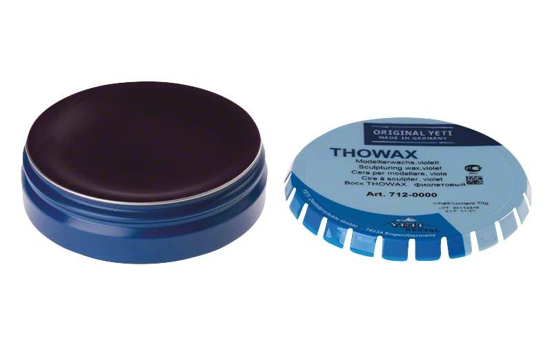 Thowax Modellierwachs violett in geöffneter blauer Dose.