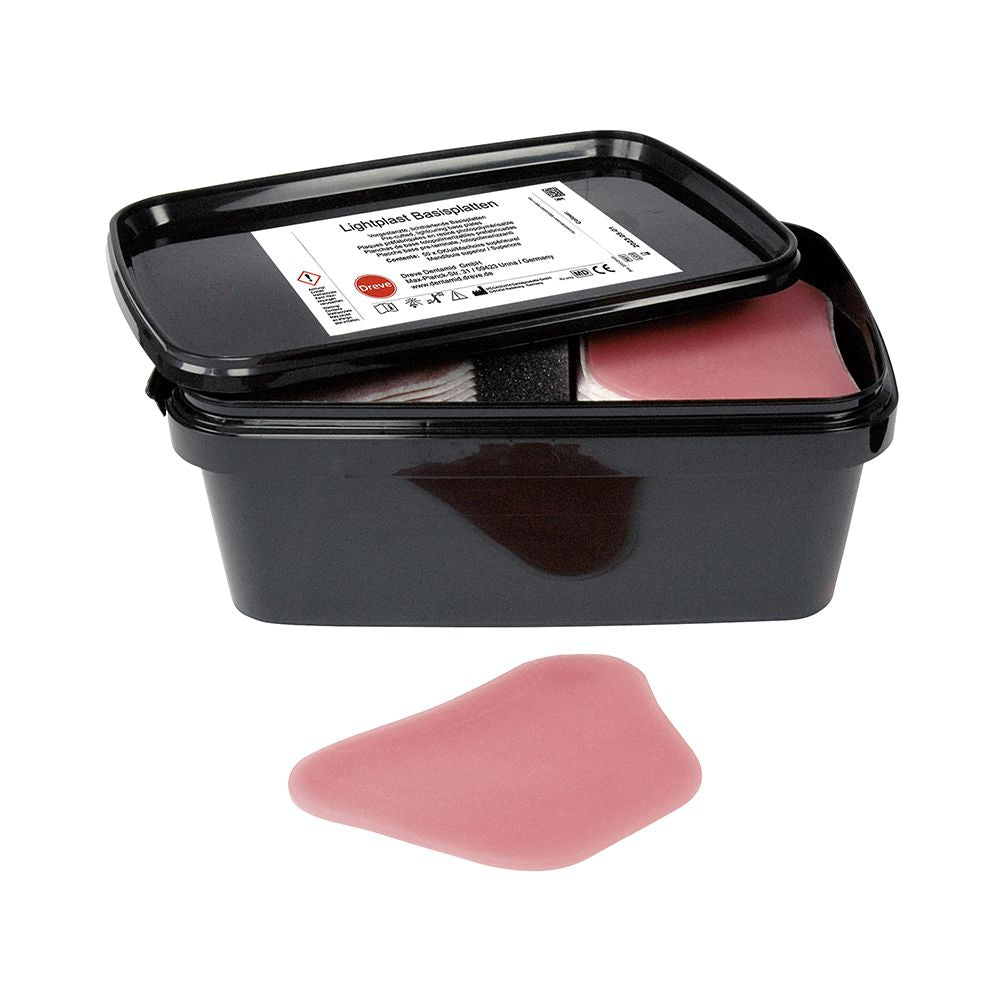 Schwarze Box mit rosa Lightplast Basisplatten für dentalen Gebrauch.