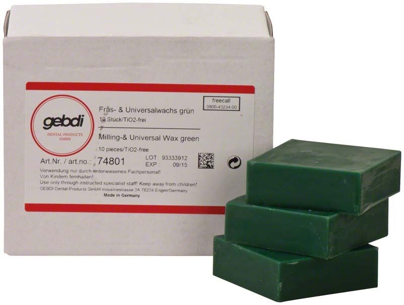 Grüne Fräswachse in Blöcken vor einer weißen Verpackung.