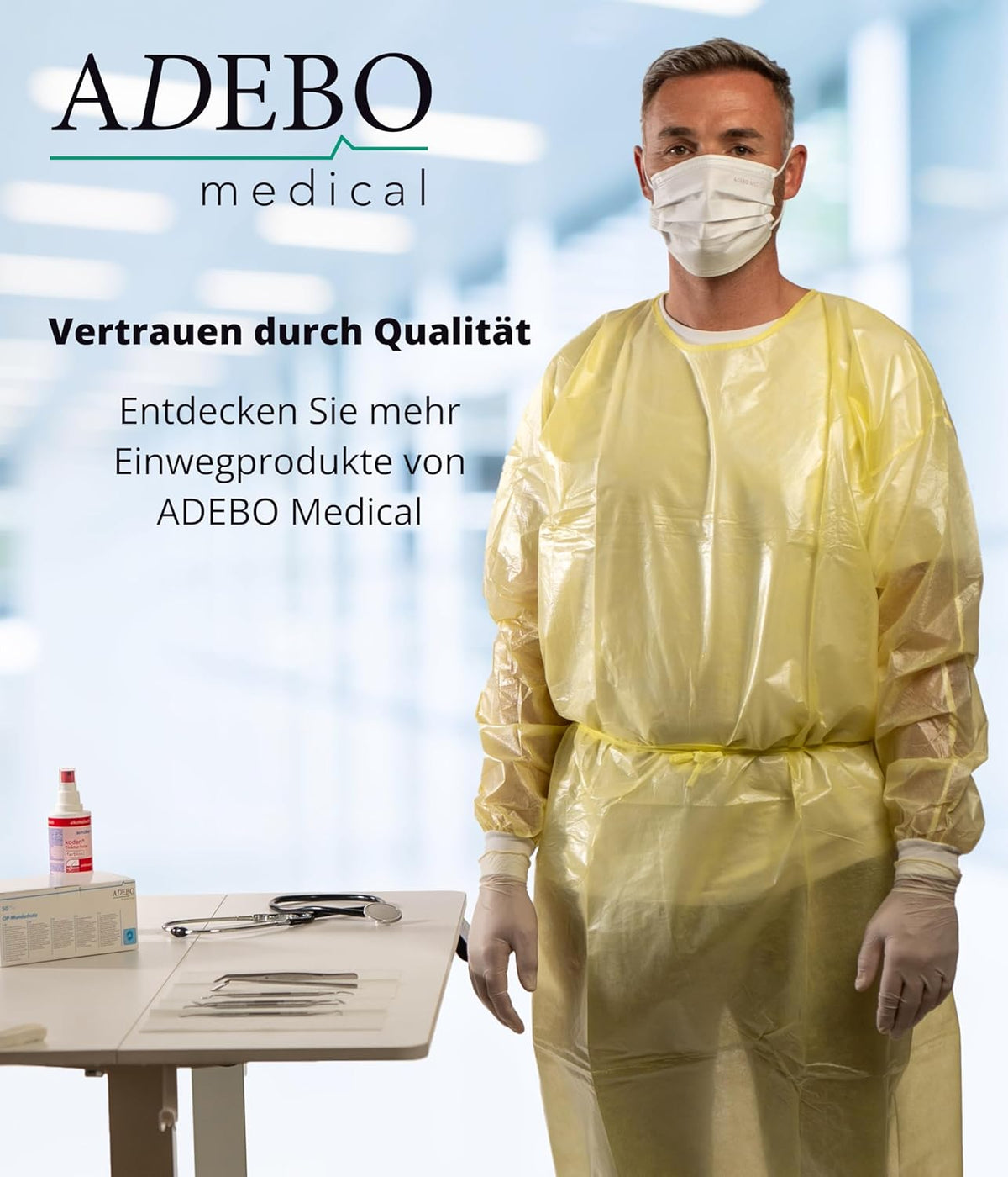 Schutzkittel 125 x 140 cm in Gelb, getragen von einem maskierten Modell in klinischer Umgebung.