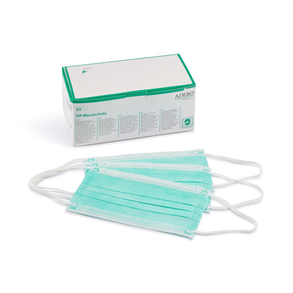 Grüner Mundschutz mit elastischen Bändern und verstellbarem Nasenbügel vor Verpackung.