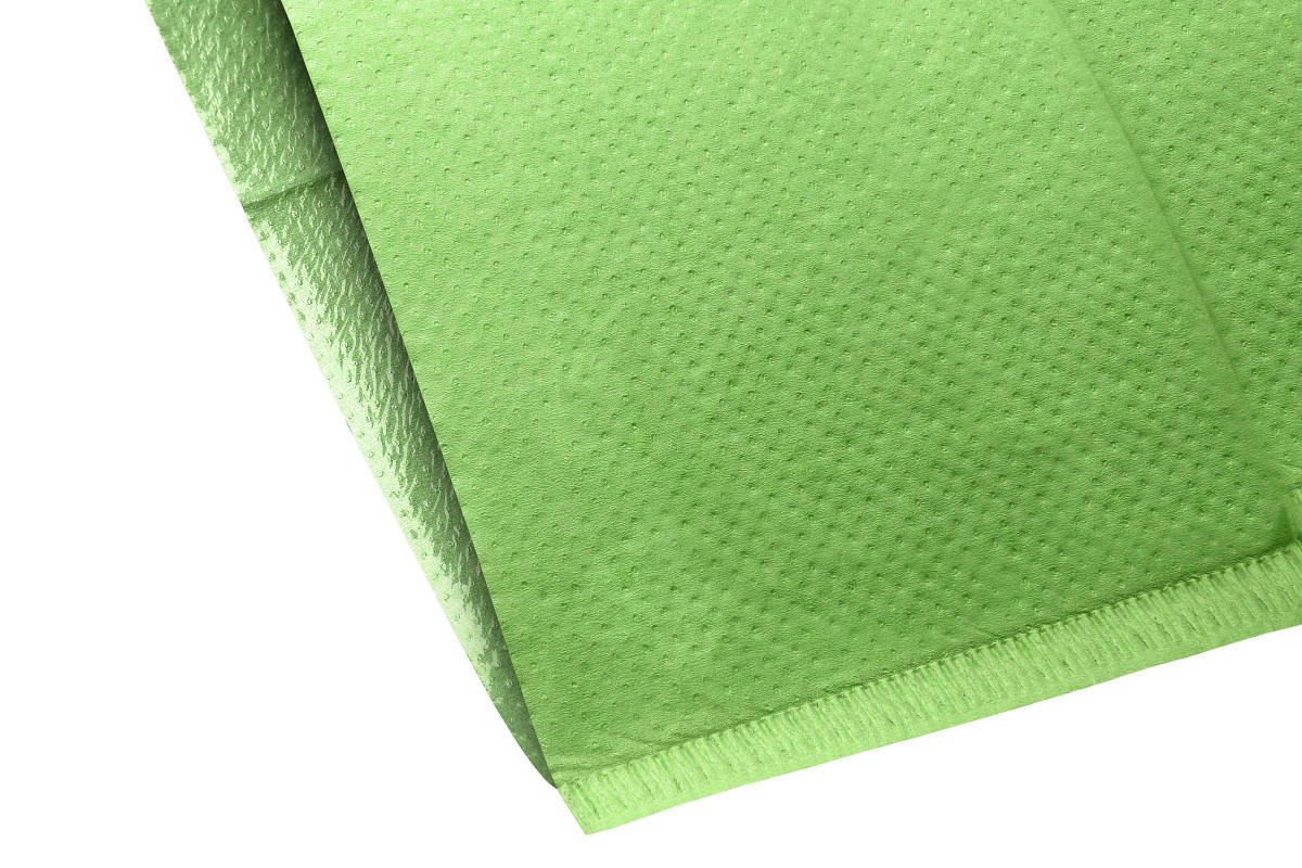 Grüner Kopfstützenüberzug mit Textur für Zahnarztstühle, Detailansicht der Materialstruktur.