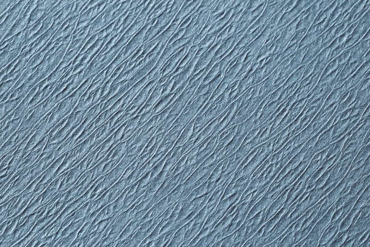 Strukturierte Nahaufnahme von blauem Norm Traypapier aus Zellstoff, 18 x 28 cm.