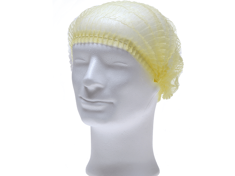 Gelbe PP Klipphaube aus leichtem Polypropylen-Spinnvlies auf Modellkopf.